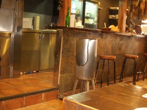 This is a shot of the bar at El Molinón.  I finally realized what the tall metal container was for.  When you pour "sidra" (a slightly alcoholic cider) you need to aerate it to release its full flavor.  To do that you hold the bottle in one hand high above your head.  You hold the glass in your other hand at about knee level.  You then pour.  If you happen to be off target, the metal container holds the spillage.